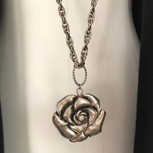 Long silver necklace with flower penant